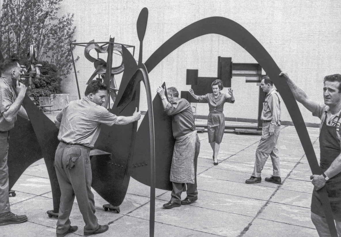 Dorothy Miller installing Alexander Calder’s Black Widow (1959), c. 1964
